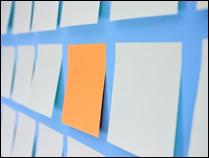Wall of advesive notes with one standing out